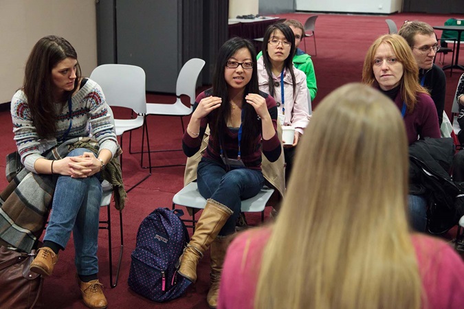 Student speaking to teacher and class Woman on computer