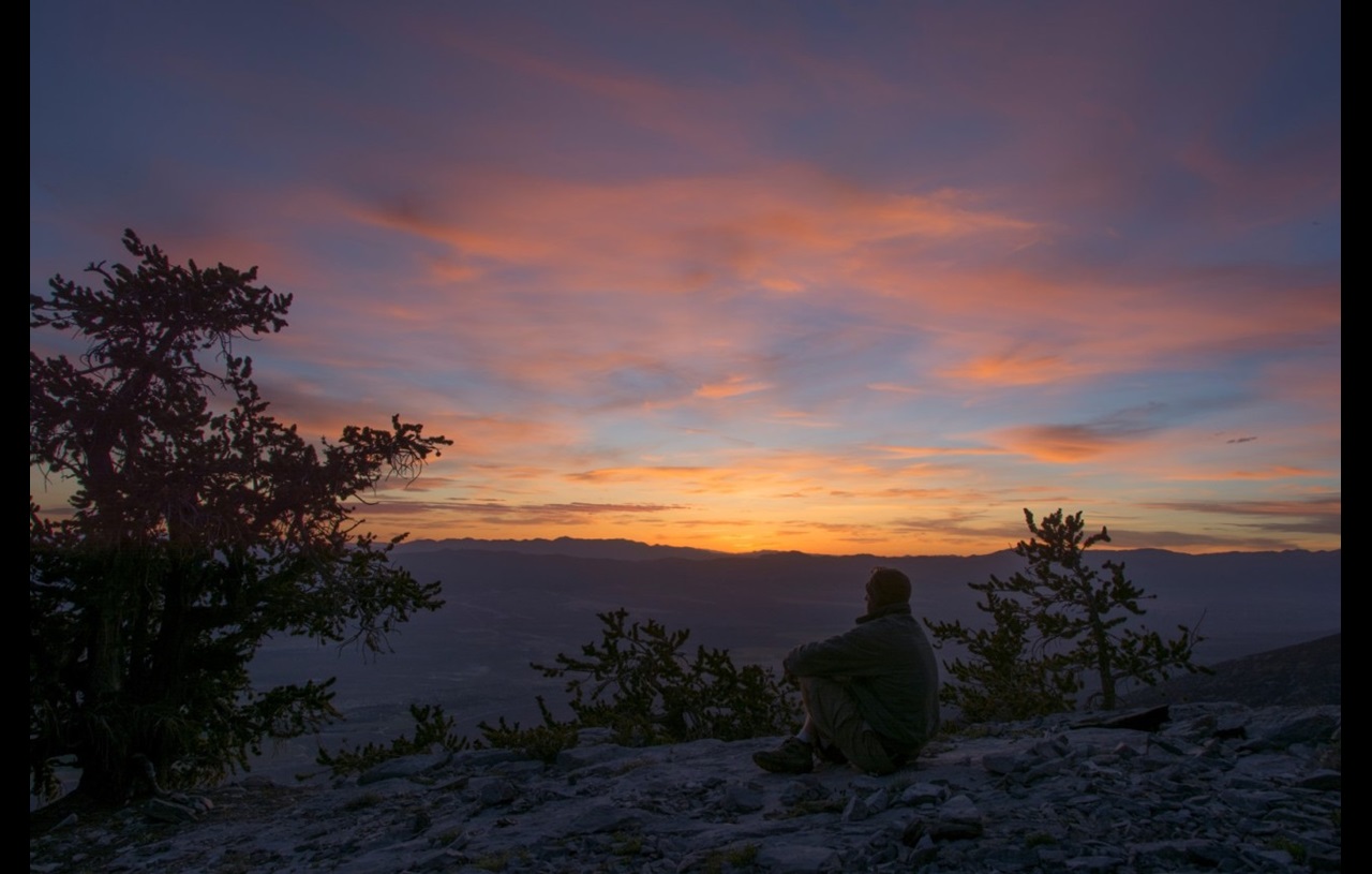 man watching sunset on Mount Washington in Nevada, USA.