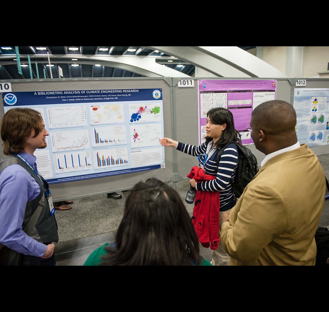 woman pointing and explaining poster to audience woman pointing and explaining poster to audience