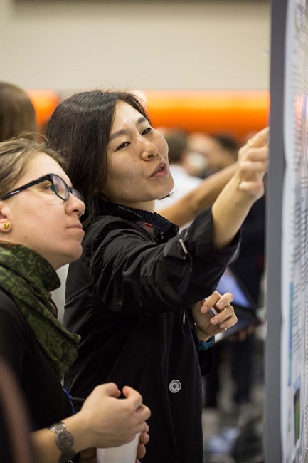 woman explaining to woman her poster
woman explaining to woman her poster