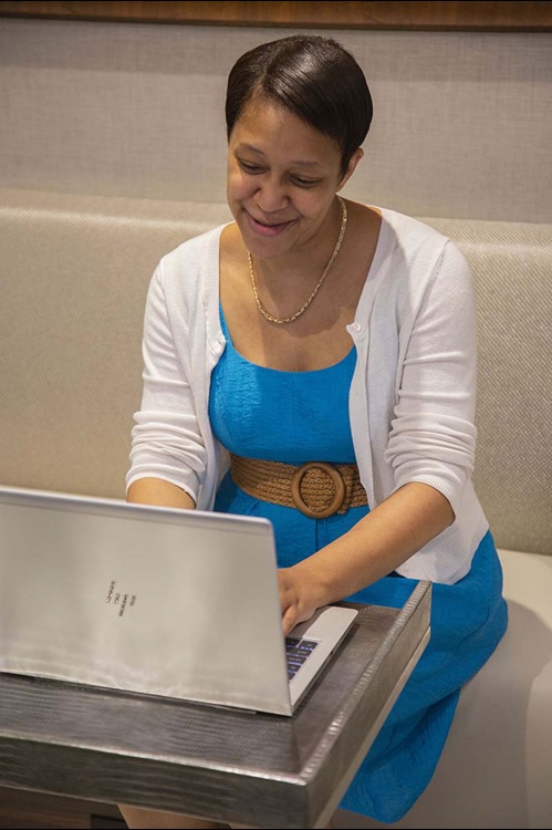 Woman smiling at computer Woman smiling at computer